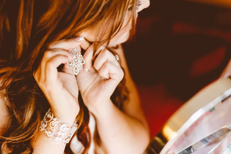 Hands fastening a chandelier earring